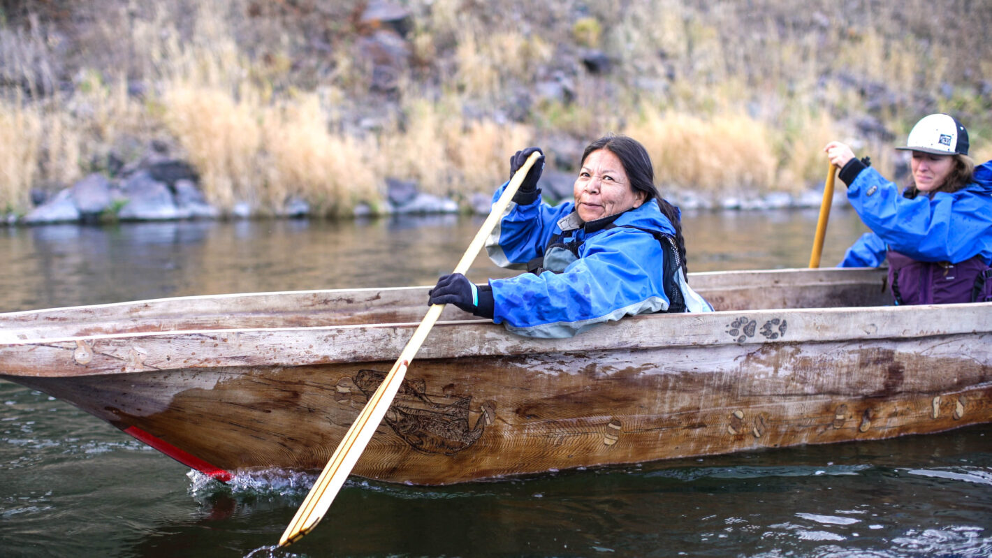 Woman patty paddling in a blue jacket