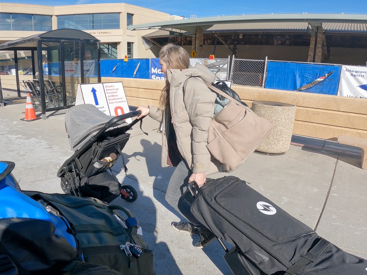 Elyse juggling multiple suitcases on the move