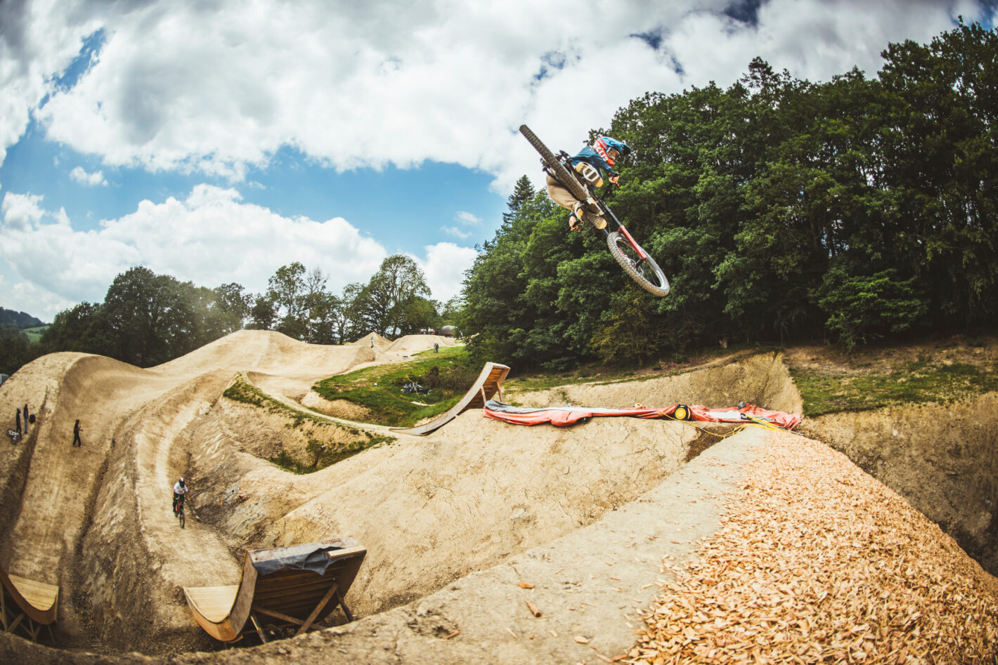 Action shot of Casey Brown mountain biking mid-air.